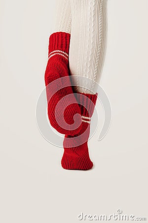 Female legs in white stockings and red knit socks. Stock Photo