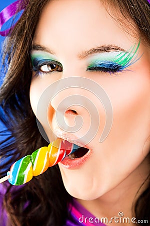 Female licking lollipop blink Stock Photo