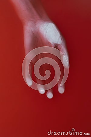 Female lifeless hand in red water, cover for art in horror genre, detective novel, concept defeat Stock Photo