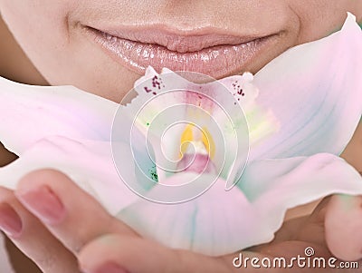 Female lips and orchid flower. Spa. Stock Photo