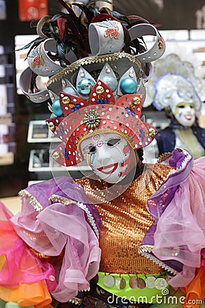 Female in a luxurious costume wearing colorful clothes and a decorative mask Stock Photo