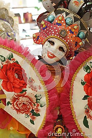 Female in a luxurious costume wearing colorful clothes and a decorative mask Stock Photo