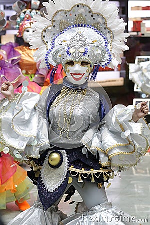 Female in a luxurious costume wearing colorful clothes and a decorative mask Stock Photo