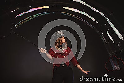 Female magician makes with soap bubbles show Stock Photo