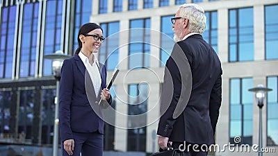 Female and male managers meeting outside office, business colleagues teamwork Stock Photo