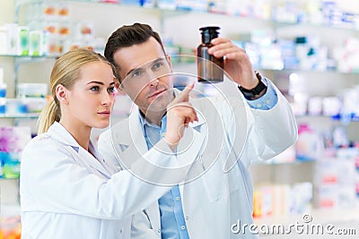 Female and male pharmacists Stock Photo