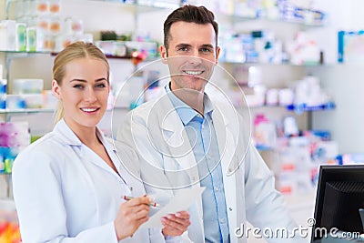 Female and male pharmacists Stock Photo
