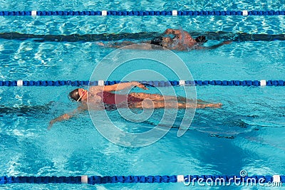 Female and male sharing laps swimming pool for fitness Editorial Stock Photo