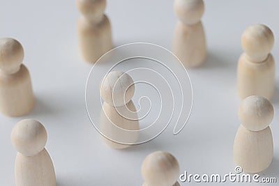 Female and male wooden figures are scattered on white background. Stock Photo