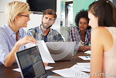 Female Manager Leading Meeting In Office Stock Photo