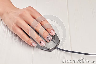 Female manicured hand using pc mouse. Stock Photo