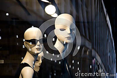 Female mannequin doll displayed n the shop window with city reflections Stock Photo