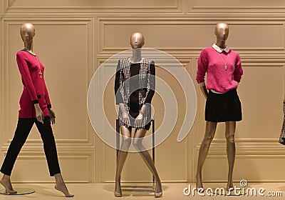 Female mannequins in a fashion clothing shop window Stock Photo