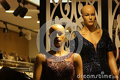 Female mannequins wearing sparkly evening dress. Stock Photo