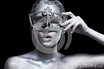 Female with masquerade venecian mask in hand near face. Silver g Stock Photo