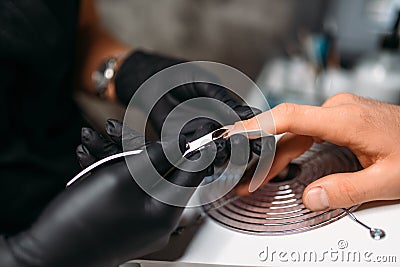 Female master makes a man manicure, nail polishing Stock Photo