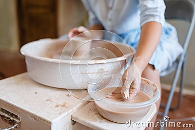 Female master making a pot on pottery wheel Stock Photo
