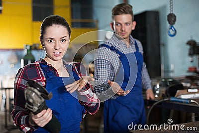 Female master is standing with circular saw Stock Photo