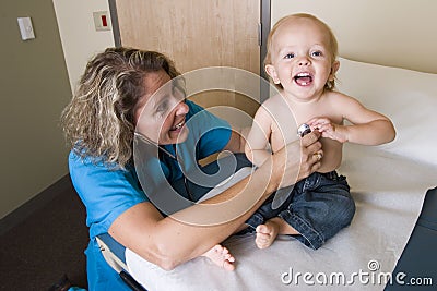 Female medical professional checking childs heart Stock Photo