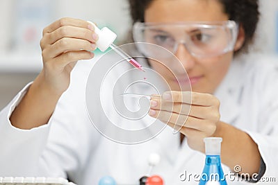 female medical worker compares test tubes with biological samples Stock Photo