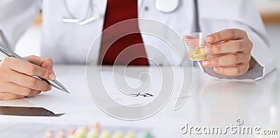 Female medicine doctor fills up prescription form to patient closeup. Panacea and life save, prescribe treatment, lega Stock Photo