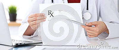 Female medicine doctor hand hold clipboard pad and give prescription to patient closeup. Panacea and life save Stock Photo