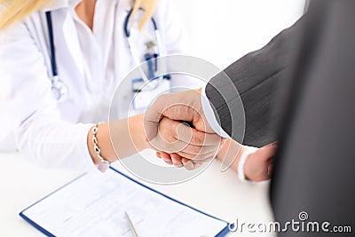 Female medicine doctor shake hand as hello Stock Photo