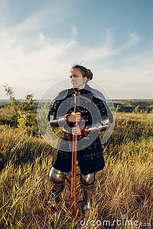 Female medieval knight poses in armor Stock Photo