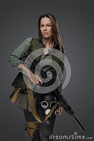Female mercenary with rifle isolated on grey background Stock Photo
