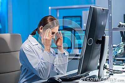 Female microelectronics engineer works in a scientific laboratory on computing systems and microprocessors. Professional Stock Photo