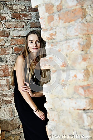 Woman in blak dress inside ruins Stock Photo