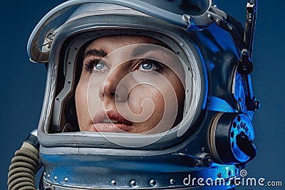 Female modern cosmonaut in spacesuit and helmet Stock Photo