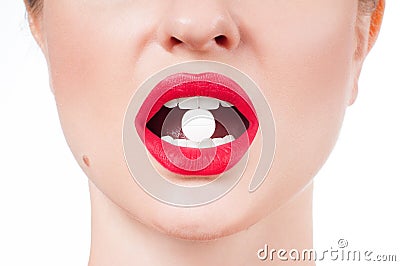 Female mouth with red lips and medicine pill Stock Photo