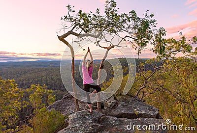 Sunset yoga meditations from cliff tops with views Stock Photo