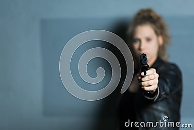 Female murderer with gun Stock Photo