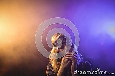 Female musician playing harmonica in nightclub Stock Photo