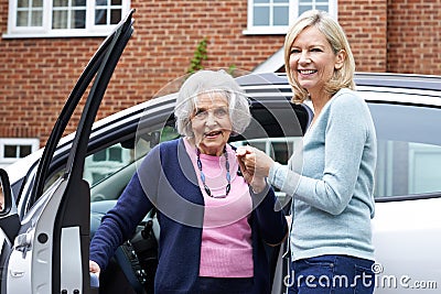 Female Neighbor Giving Senior Woman A Lift In Car Stock Photo