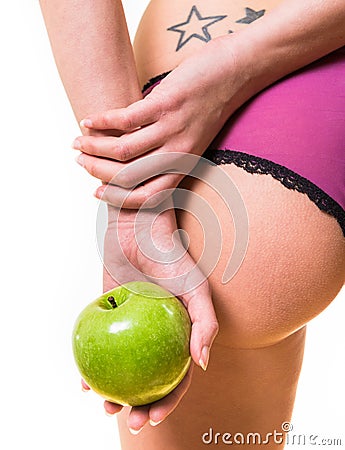 Female with nice buttocks and apple in hand Stock Photo