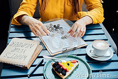 Female numerologist hand working with numerology tables with numbers Stock Photo