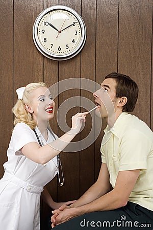 Female nurse examinating man's mouth. Stock Photo