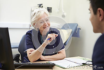 Female Nurse Meeting With Male Patient Stock Photo