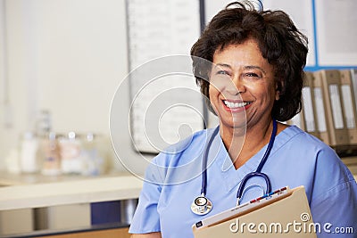 Female Nurse At Nurses Station Stock Photo