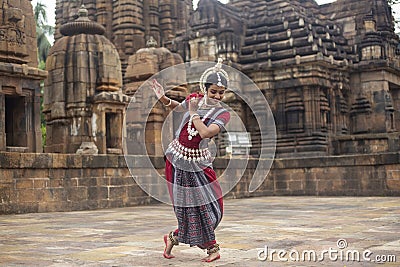 Female Odissi Dancer wears traditional costume with hand mudra at Mukteshvara Temple, bhubaneswar Stock Photo