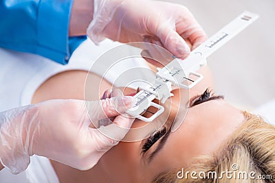 Female ophthalmologist is checking up female patient in eye doct Stock Photo