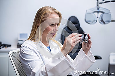 Female optometrist looking through messbrille Stock Photo