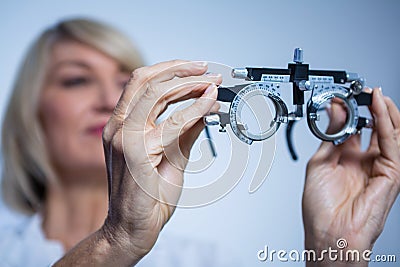 Female optometrist looking at messbrille Stock Photo