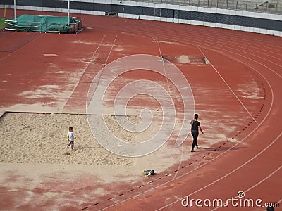 Female parents play with their young children in the sand pit of the sports center Editorial Stock Photo