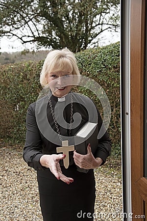 Female parish priest on a house call Stock Photo