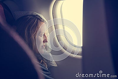 Female passenger sleeping covered with blanket. Stock Photo