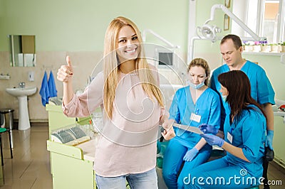 Female patien with three doctors at the dental office Stock Photo